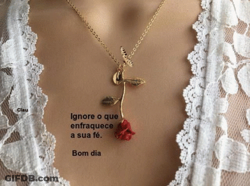A Woman Is Wearing A Necklace With A Red Rose Pendant GIF