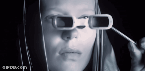 A Woman Is Wearing A Pair Of Sunglasses That Have A Hole In Them GIF