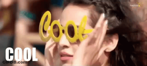 A Woman Is Wearing A Pair Of Yellow Sunglasses That Say Cool . GIF
