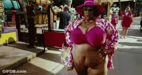 A Woman Is Wearing A Pink Bikini Top And A Pink Hat . GIF