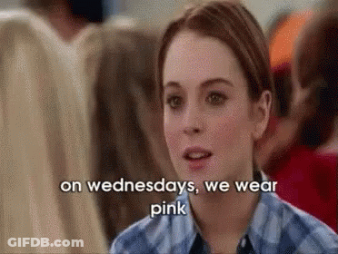 A Woman Is Wearing A Plaid Shirt And Talking About Wearing Pink On Wednesdays . GIF