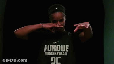 A Woman Is Wearing A Purdue Basketball Shirt And Covering Her Mouth With Her Hands . GIF