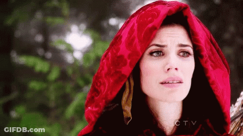 A Woman Is Wearing A Red Hood And Holding A Sword . GIF