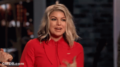 A Woman Is Wearing A Red Jacket And Giving A Thumbs Up Sign . GIF