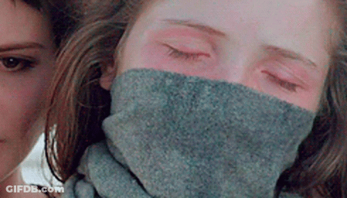 A Woman Is Wearing A Scarf Around Her Neck . GIF
