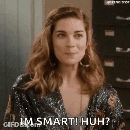 A Woman Is Wearing A Sequined Jacket And Earrings And Says `` Im Smart ! Huh ? '' . GIF
