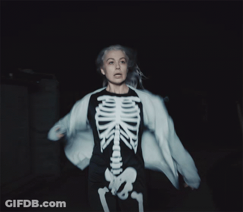 A Woman Is Wearing A Skeleton Costume And A White Jacket GIF