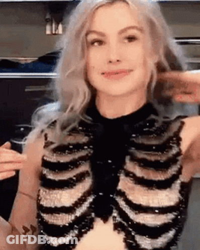 A Woman Is Wearing A Skeleton Costume And Making A Face . GIF