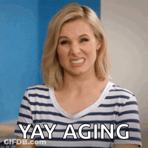 A Woman Is Wearing A Striped Shirt And Says Yay Aging GIF