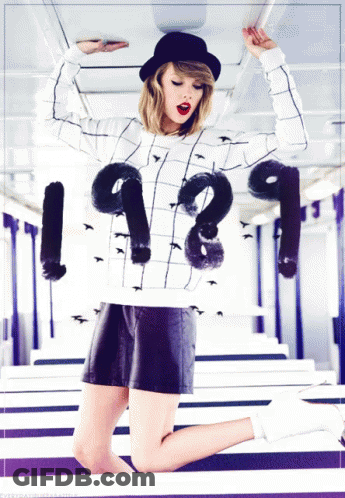 A Woman Is Wearing A Sweater That Says 1989 GIF