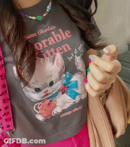 A Woman Is Wearing A T-Shirt That Says " Adorable Kitten " GIF
