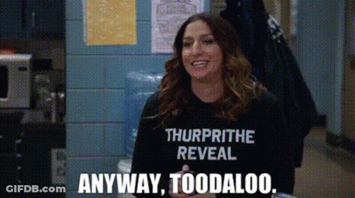 A Woman Is Wearing A T-Shirt That Says `` Thurprithe Reveal '' And Is Smiling . GIF