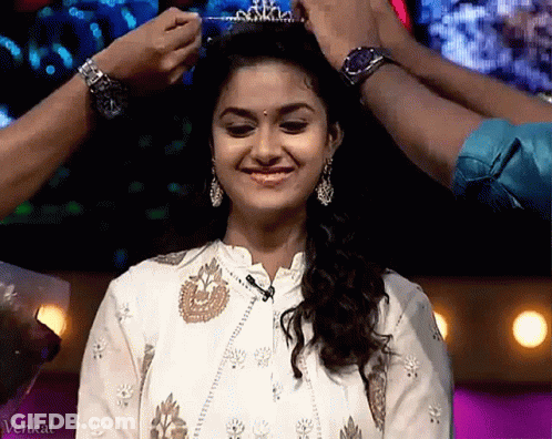 A Woman Is Wearing A Tiara On Her Head GIF
