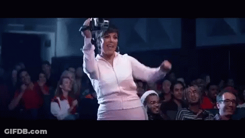 A Woman Is Wearing A Virtual Reality Headset While Dancing In Front Of A Crowd . GIF
