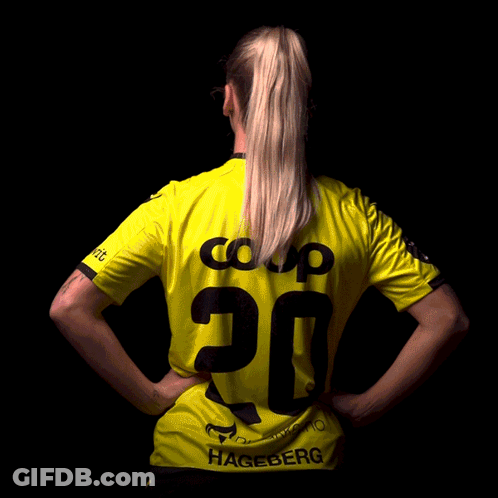 A Woman Is Wearing A Yellow Shirt With The Number 20 On The Back GIF