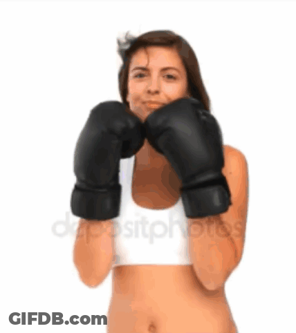 A Woman Is Wearing Boxing Gloves And A White Tank Top GIF
