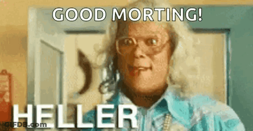 A Woman Is Wearing Glasses And A Blue Shirt And Says `` Good Morning Heller '' . GIF