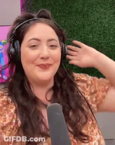 A Woman Is Wearing Headphones And A Microphone And Making A Funny Face GIF