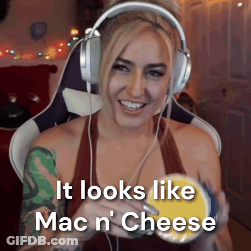A Woman Is Wearing Headphones And Holding A Bowl Of Mac N Cheese GIF