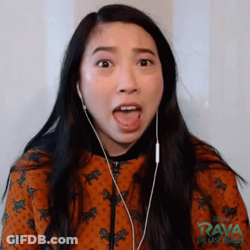 A Woman Is Wearing Headphones And Making A Funny Face While Listening To Music . GIF
