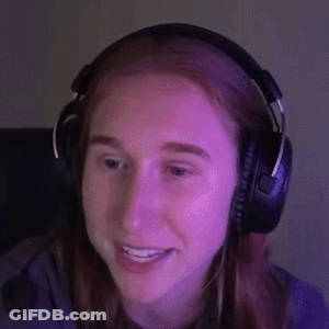 A Woman Is Wearing Headphones And Smiling While Sitting In Front Of A Computer Screen . GIF