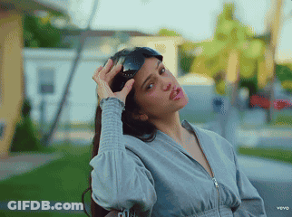 A Woman Is Wearing Sunglasses And Making A Funny Face In A Video For Vevo GIF