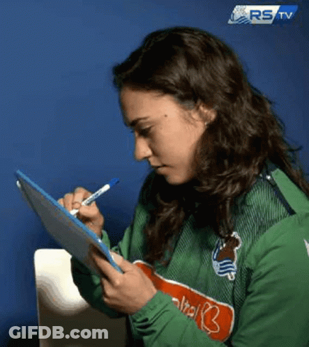 A Woman Is Writing On A Clipboard With A Pen . GIF