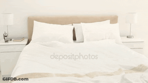 A Woman Jumping On A Bed With The Word Depositphotos On The Bottom Left GIF