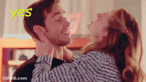A Woman Kisses A Man On The Forehead With The Word Yes Behind Them GIF