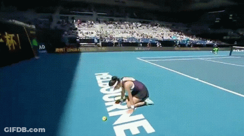 A Woman Kneeling Down On A Tennis Court With The Word Melbourne On The Ground GIF