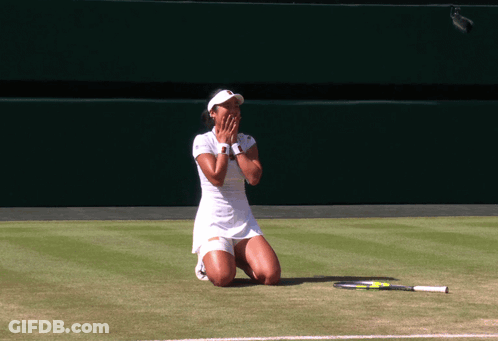 A Woman Kneeling On A Tennis Court With A Racket On The Ground GIF