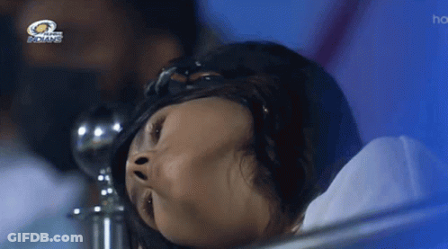 A Woman Laying In A Hospital Bed With The Indians Logo Above Her GIF