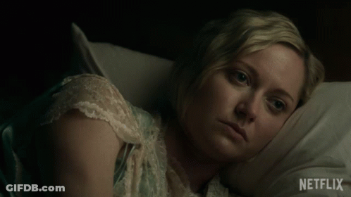 A Woman Laying In Bed With A Netflix Logo On The Bottom Right GIF