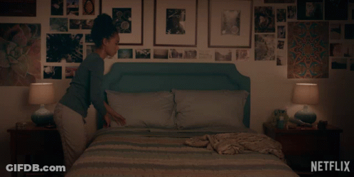 A Woman Laying On A Bed With A Netflix Logo On The Bottom Right GIF