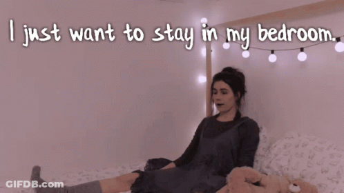 A Woman Laying On A Bed With The Words I Just Want To Stay In My Bedroom GIF