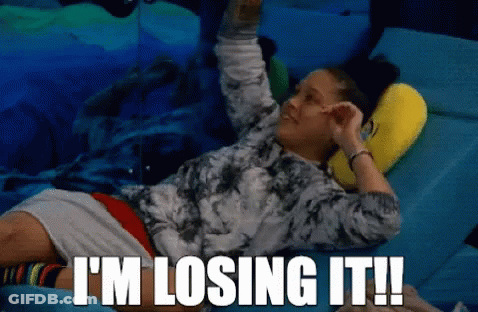 A Woman Laying On A Bed With The Words " I 'M Losing It " Written Above Her GIF