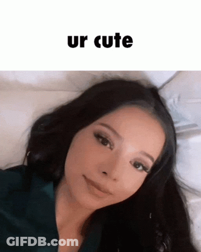 A Woman Laying On A Bed With The Words Ur Cute Written Above Her GIF