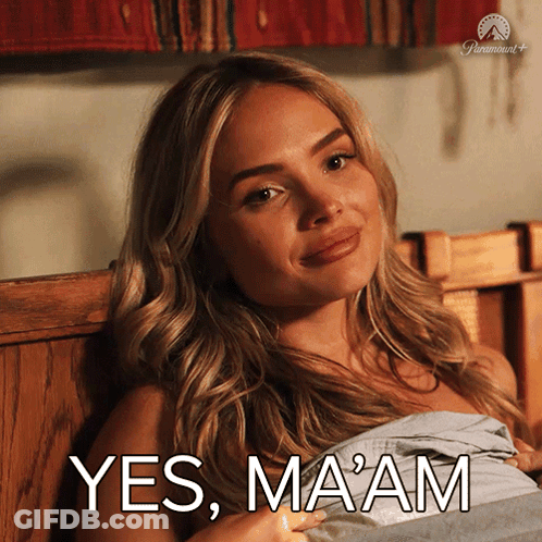 A Woman Laying On A Bed With The Words Yes Ma Am Written On The Bottom GIF