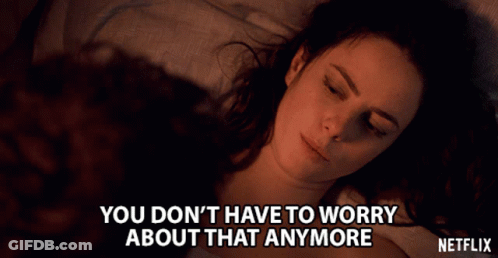 A Woman Laying On A Bed With The Words " You Don T Have To Worry About That Anymore " GIF