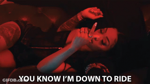 A Woman Laying On A Man 'S Lap With The Words " You Know I 'M Down To Ride " Below Her GIF