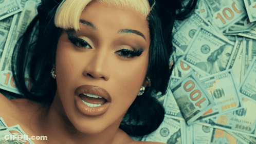 A Woman Laying On Top Of A Pile Of 100 Dollar Bills GIF