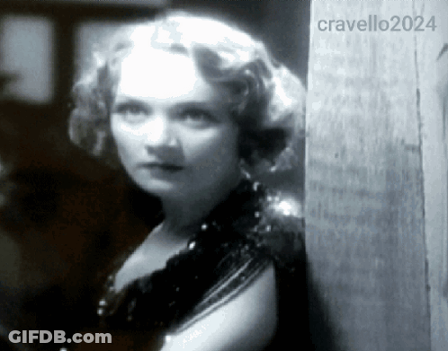A Woman Leaning Against A Wall With The Year 2024 On The Bottom Right GIF