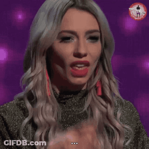 A Woman Licks Her Finger While Wearing A T-Shirt That Says ' T-Shirt ' On It GIF