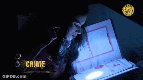 A Woman Looking At A Book With The Word Crime On The Bottom GIF