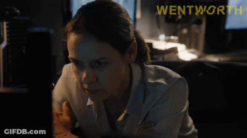 A Woman Looking At A Computer Screen With The Word Wentworth On The Bottom Right GIF
