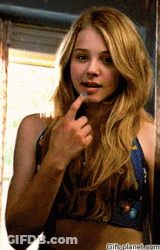 A Woman Looking At Herself In A Mirror With Gifs-Planet.com At The Bottom Of The Image GIF