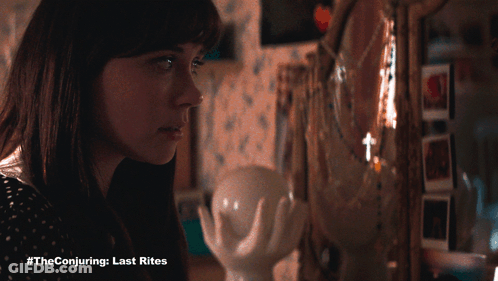 A Woman Looking At Herself In A Mirror With #Theconjuring Last Rites Written On The Bottom GIF