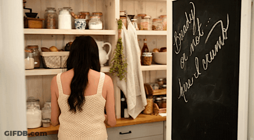 A Woman Looking Into A Pantry With A Chalkboard That Says Ready Or Not GIF