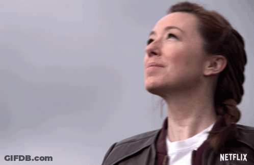 A Woman Looking Up With A Netflix Logo In The Background GIF