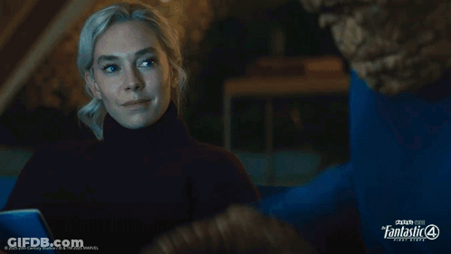 A Woman Looks At A Man In A Blue Shirt That Says Fantastic Four GIF